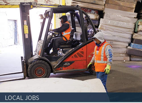 Interior - A forklift and stacks of mattresses.